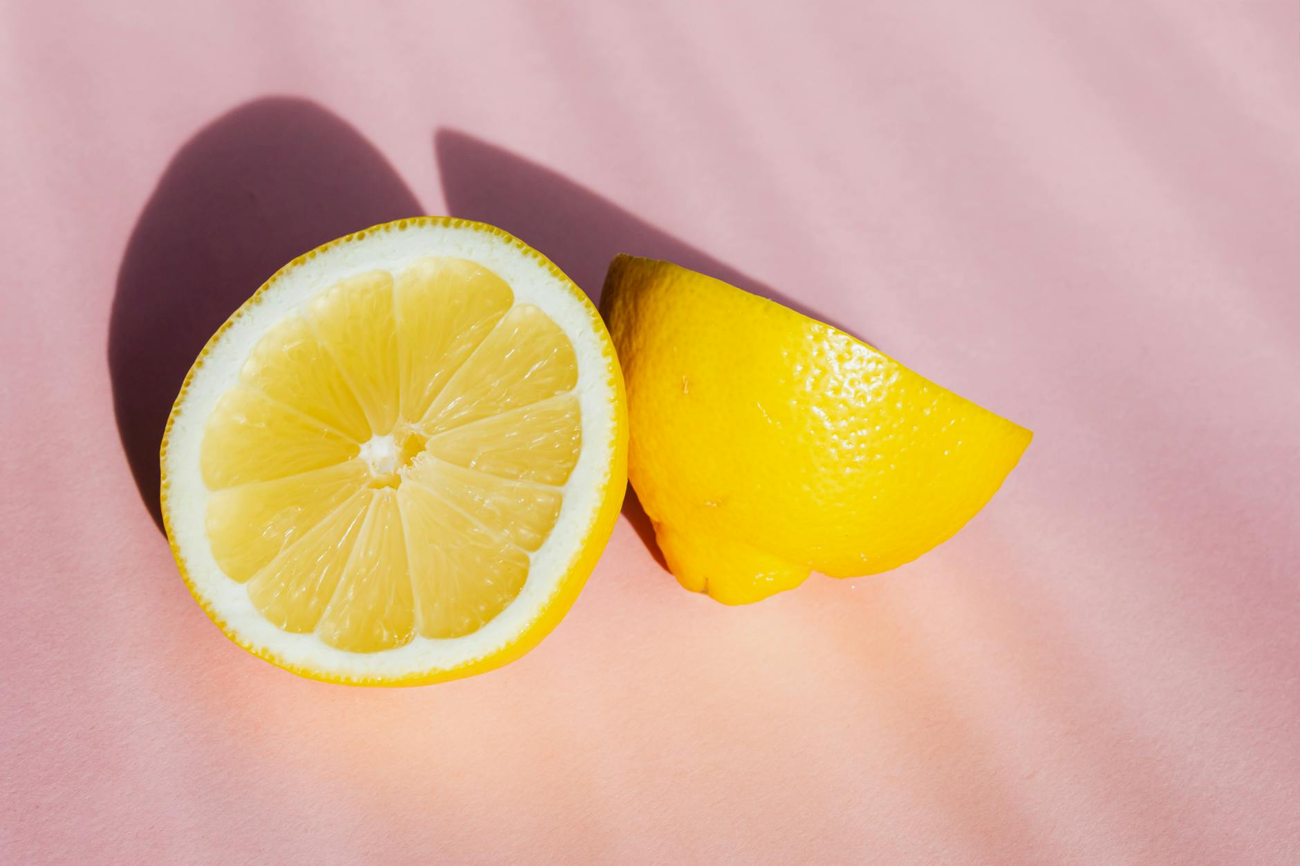Ripe lemons with visible pedicels on a pastel background, representing fresh vitality and renewal
