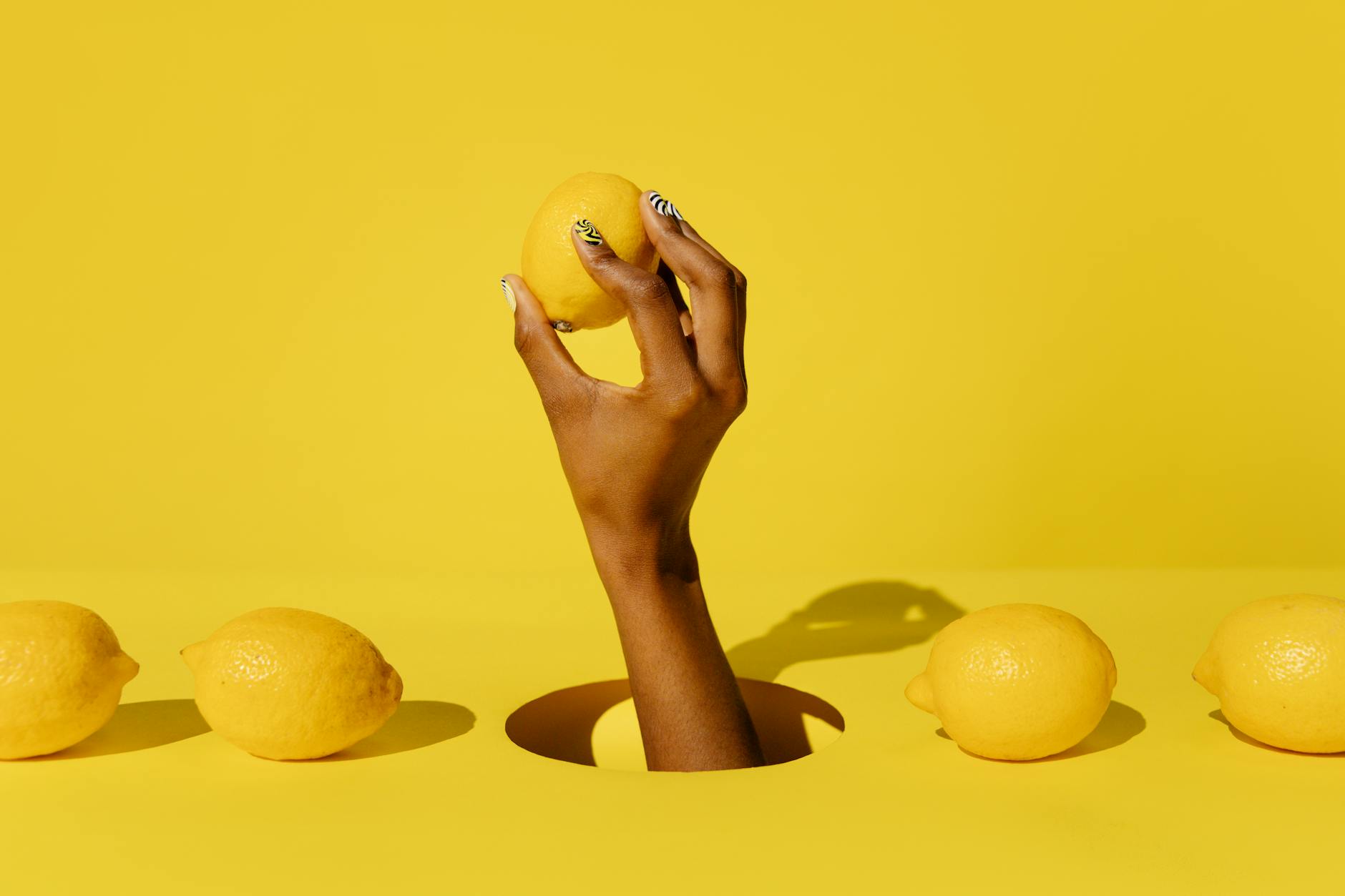 Close-up of a hand holding an orange vibrator against a purple backdrop, symbolizing reclaiming pleasure safely