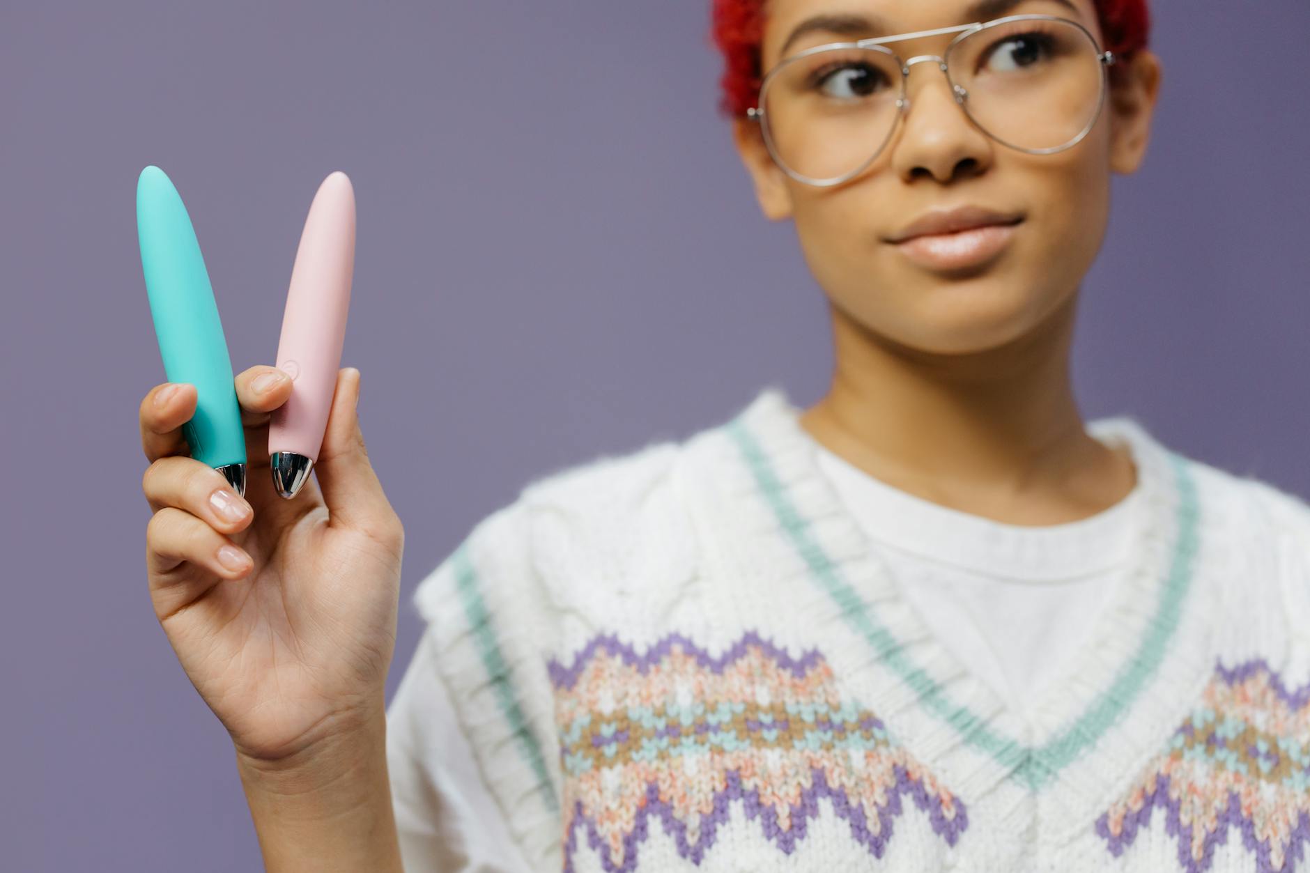 A blue silicone vibrator held in hand against a solid background, promoting self-love and sensation recovery