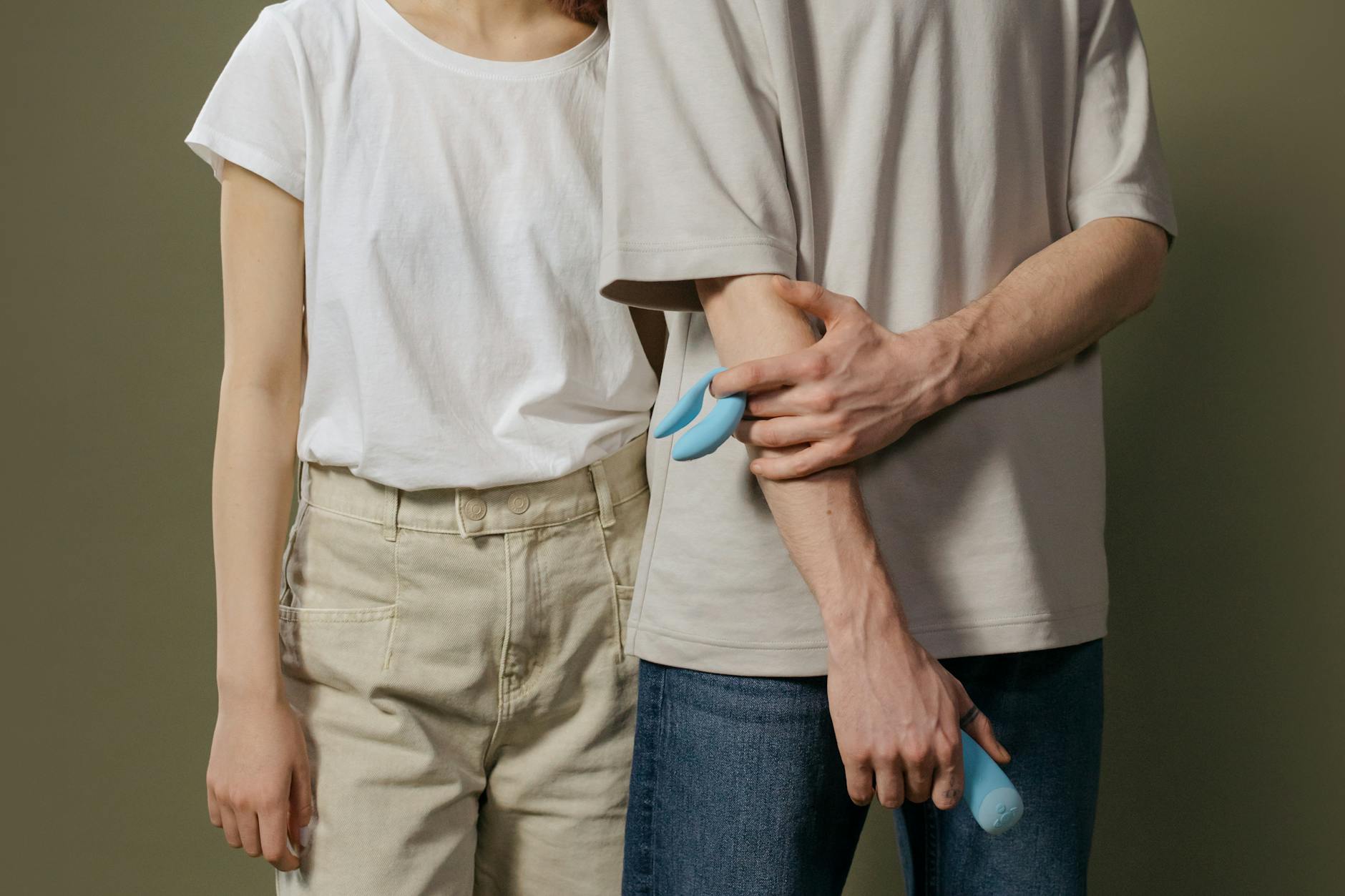 A young couple standing together indoors, exploring modern ways to stay intimate despite the distance.