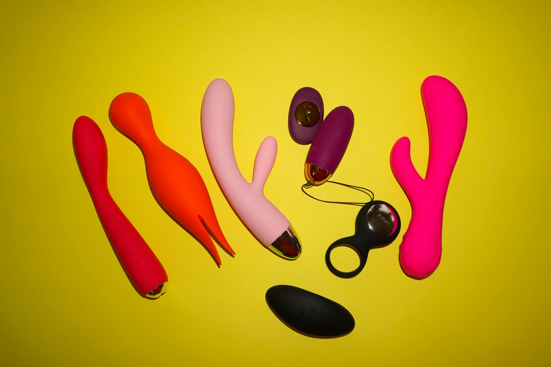 Blue silicone vibrator held in hand against purple background, promoting self-love and intimacy