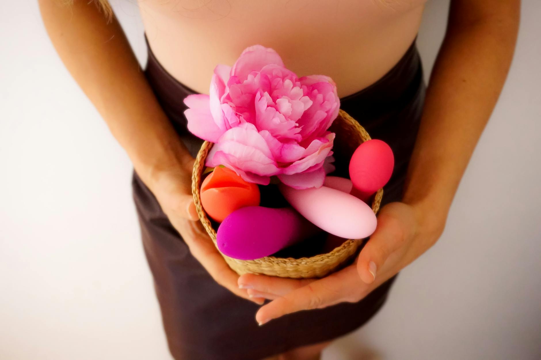 Array of vibrant adult toys on a bright yellow surface, showcasing design diversity